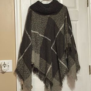 Poncho 100 % acrylic. So soft shades of tan, white and cream color one size